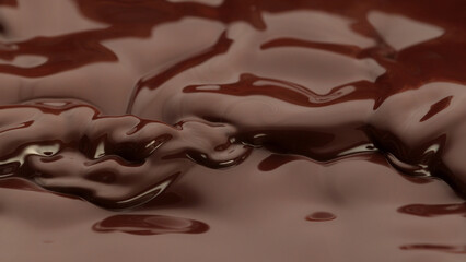 Melted chocolate in detail, floating on surface.