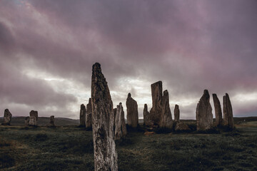 Ancient magic in the Calanais Standing Stones Circle, megaliths erected by neolithic men for worship. Celtic traditions in the outer hebrides of Scotland. Touristic attraction.