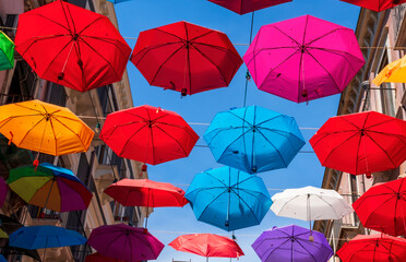 Obraz premium Colorful umbrellas background. Colorful umbrellas in the sky. Street decoration.