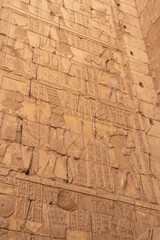 Wall of hieroglyphs in Karnak temple closeup. Egypt. Vertically.