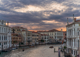 Incredible sunset, clouds and traditional venetian architecture seen from the grand canal in Venice, Italy
