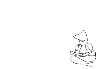 a little smart boy is sitting on the floor carefully reading a book studying