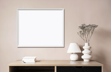 Empty horizontal frame mockup in modern minimalist interior with plant in trendy vase on beige wall...
