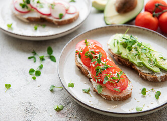 Different sandwiches with vegetables and microgreens