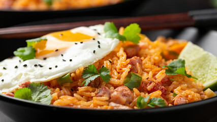 Kimchi fried rice with fried egg and bacon. Korean food
