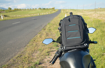 Backpack with a motorcycle at outdoors. Ready for adventure and travel
