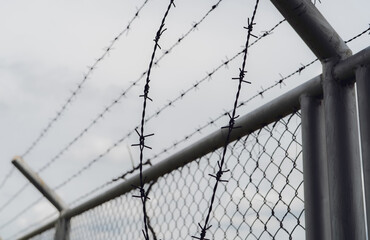 Prison security fence. Border fence. Barbed wire security fence. Razor wire jail fence. Boundary...