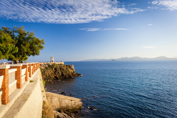 Sunset view of Piazza Bovio with lighthouse in Piombino and Elba Island - 516137553