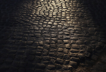 old cobblestone road in a beam of light