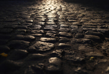 an old cobblestone road in a beam of light