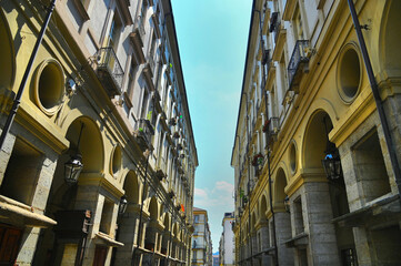 Fototapeta na wymiar Perspective view of baroque style downtown ancient buildings and arcades Turin Italy July 9 2022