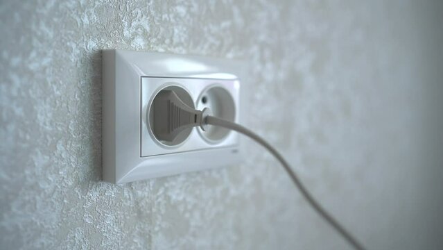 Woman hands switch on the power plug into the white electrical socket. Main pulls out the electrical plug in socket wire. 