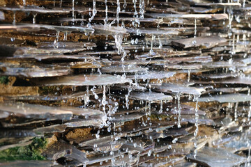 Artificial waterfall. The water is hitting the edge of the rock.