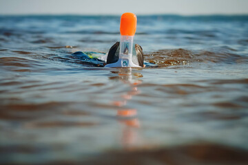 cute little caucasian boy wearing snorkeling maskswimming in the sea