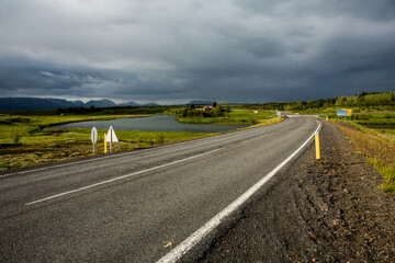 Very picturesque empty road in iceland in summer. Asphalt road as a symbol of freedom and travel.