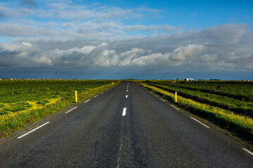 Very picturesque empty road in iceland in summer. Asphalt road as a symbol of freedom and travel.