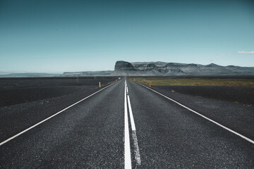 Very picturesque empty road in iceland in summer. Asphalt road as a symbol of freedom and travel.