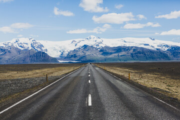 Very picturesque empty road in iceland in summer. Asphalt road as a symbol of freedom and travel.