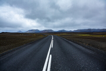 Very picturesque empty road in iceland in summer. Asphalt road as a symbol of freedom and travel.