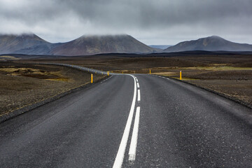 Very picturesque empty road in iceland in summer. Asphalt road as a symbol of freedom and travel.