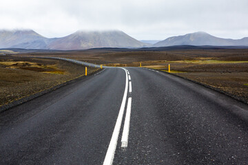 Very picturesque empty road in iceland in summer. Asphalt road as a symbol of freedom and travel.