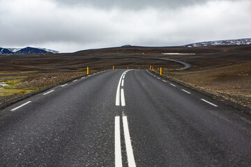 Fototapeta na wymiar Very picturesque empty road in iceland in summer. Asphalt road as a symbol of freedom and travel.