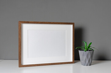 Fototapeta na wymiar Landscape blank frame mockup with home flower pot