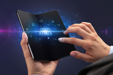 Businessman holding a foldable smartphone, security concept