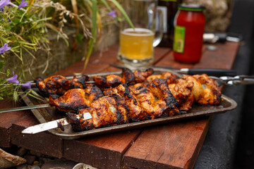Traditioanal chicken shish kebab on skewers cookeg on open fire