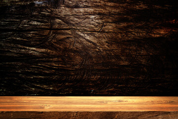 Wooden table in dark room background concept for advertising.	
