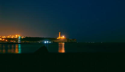 Two lighthouses at night over ocean, Portim&atilde;o Algarve Portugal