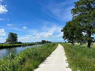 Fototapeta na wymiar Path next to a canal around Steenwijkerwold