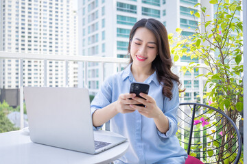 Image of young Asian business woman working at home