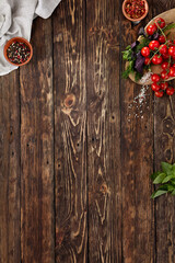 Dark wooden food background. Wooden background with ingredients in rustic style. Food background with empty place. Dark wooden table with copy space for menu. Concept food menu.