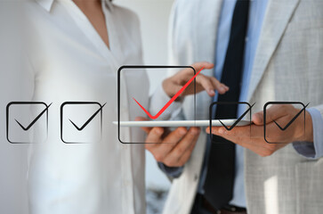 Illustration of check boxes with marks and people using tablet, closeup