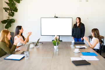 Business partners clapping during a work presentation and meeting