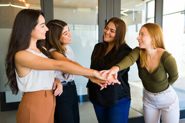 Female co-workers feeling happy to work together at the office