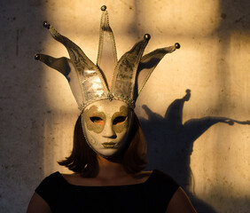 Portrait of young woman wearing carnival mask