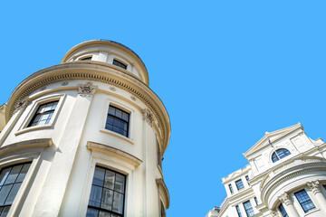 Generic London architecture against blue sky background with space for text.