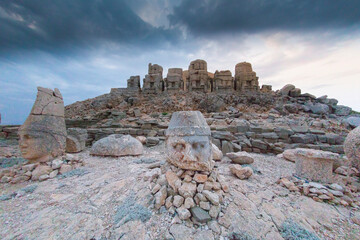 East terrace of Mount Nemrut at sunrise with Great alter in front of statues and the tumulus. The...