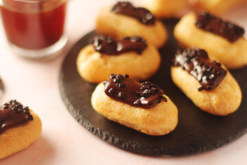 Traditional French dessert - eclairs with a cup of coffee