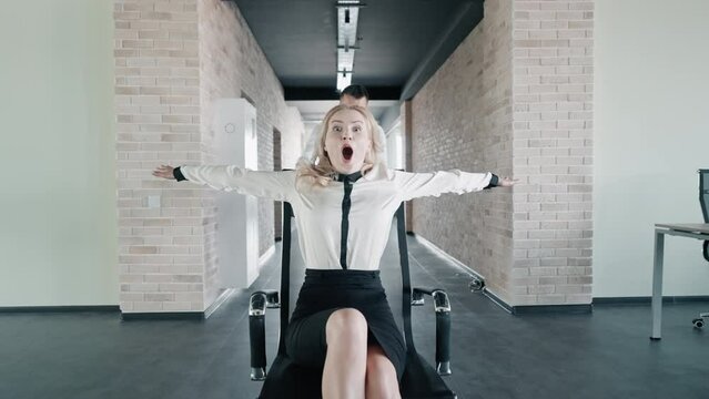 managers have fun racing on office chairs happy day at workspace in modern office