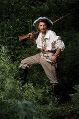 Sea robber ship captain armed pirate goes through jungle. Concept historical halloween. Filibuster cosplay