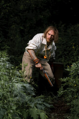 Sea robber ship captain armed pirate goes through jungle with chest of treasures. Concept historical halloween. Filibuster cosplay