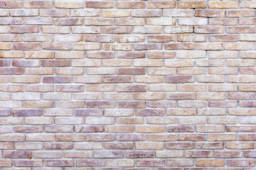 The wall is made of motley brownish-beige bricks. Full screen image. Not a seamless texture.