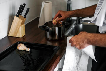  adult man marinates meat for cooking dinner in the oven