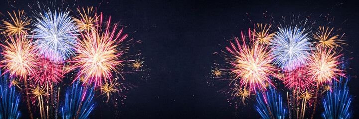 Fototapeta premium Fireworks pyrotechnics celebration party event festival holiday or New Year background panorama - Colorful firework on dark night sky..