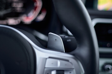 The pad of the automatic gearbox on the steering wheel of the BMW 740D. Poland, Katowice, 14.06.2021