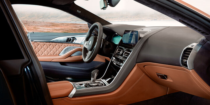 BMW M8 First Edition interior with open driver's door.  Photo assembled with a landscape of Iceland's landscape. Katowice, Poland - 13.06.2021