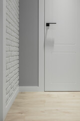 Grey entrance hallway with wardrobe and white doorway to the living room. Close up. High quality photo